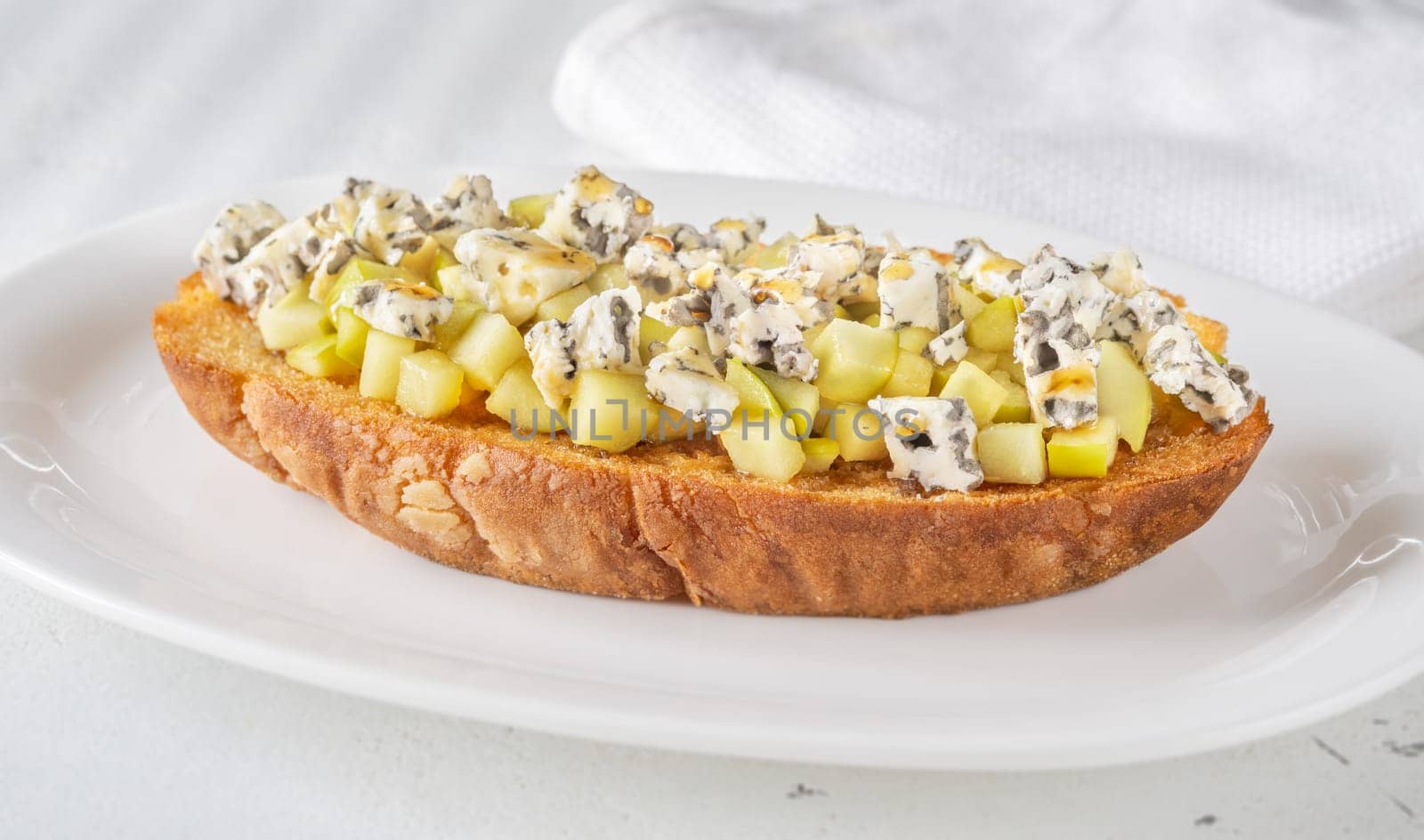 Golden toast hugs melted blue cheese, sweet apples, and warm honey drizzle