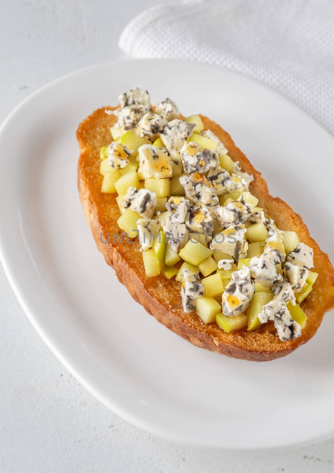 Golden toast hugs melted blue cheese, sweet apples, and warm honey drizzle