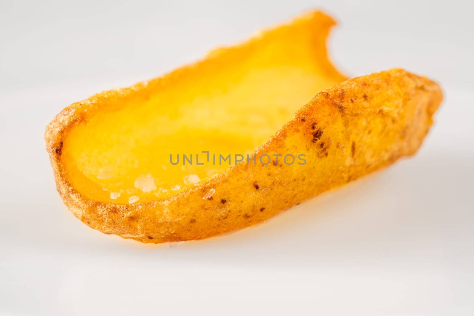 Golden dipper rests alone in focus, edges crisp and texture richly detailed