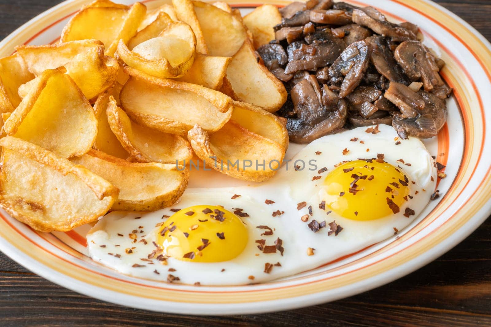 A hearty breakfast dish with crisp dippers, runny eggs, and sauteed mushrooms