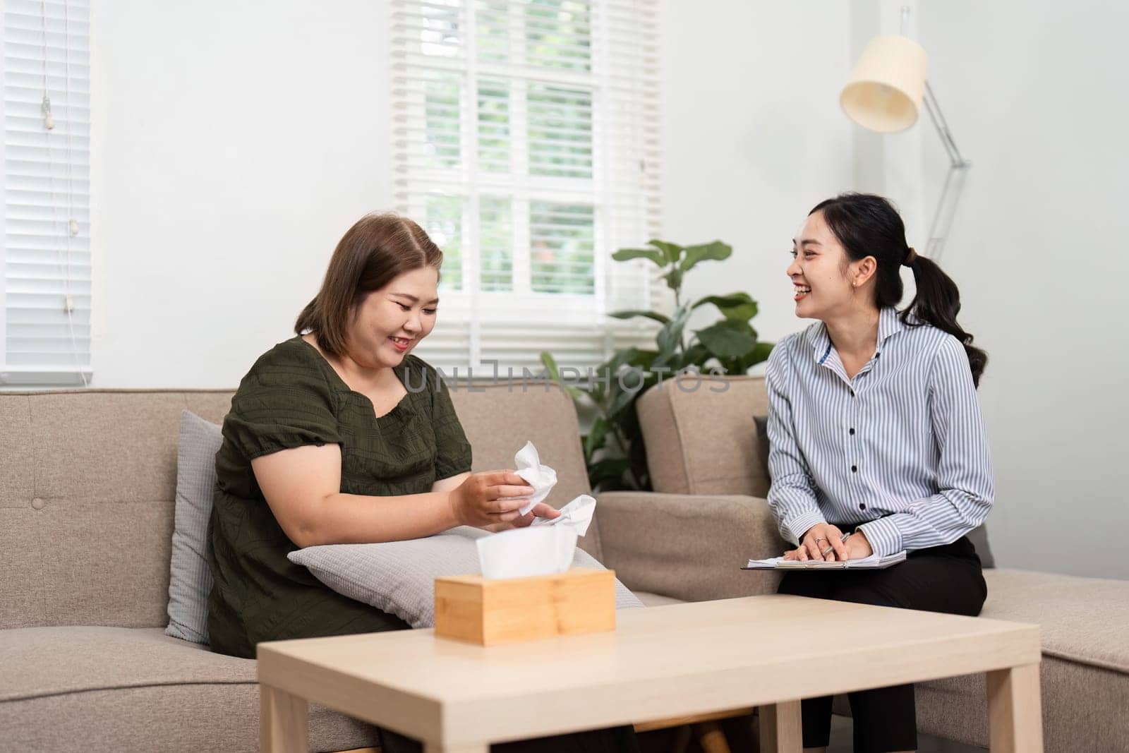 Laughter and sharing fills the room as a patient opens up about a positive moment, fostering a joyful and healing environment in therapy.
