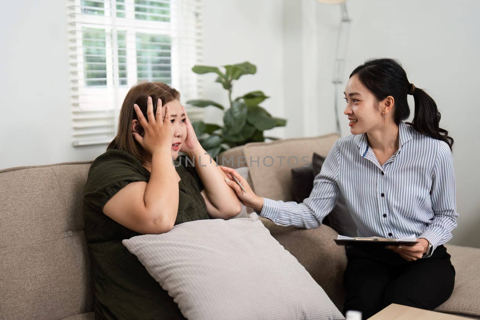 A psychiatrist provides a reassuring presence as her client navigates feelings of distress, emphasizing the importance of emotional release and reflection in therapy.