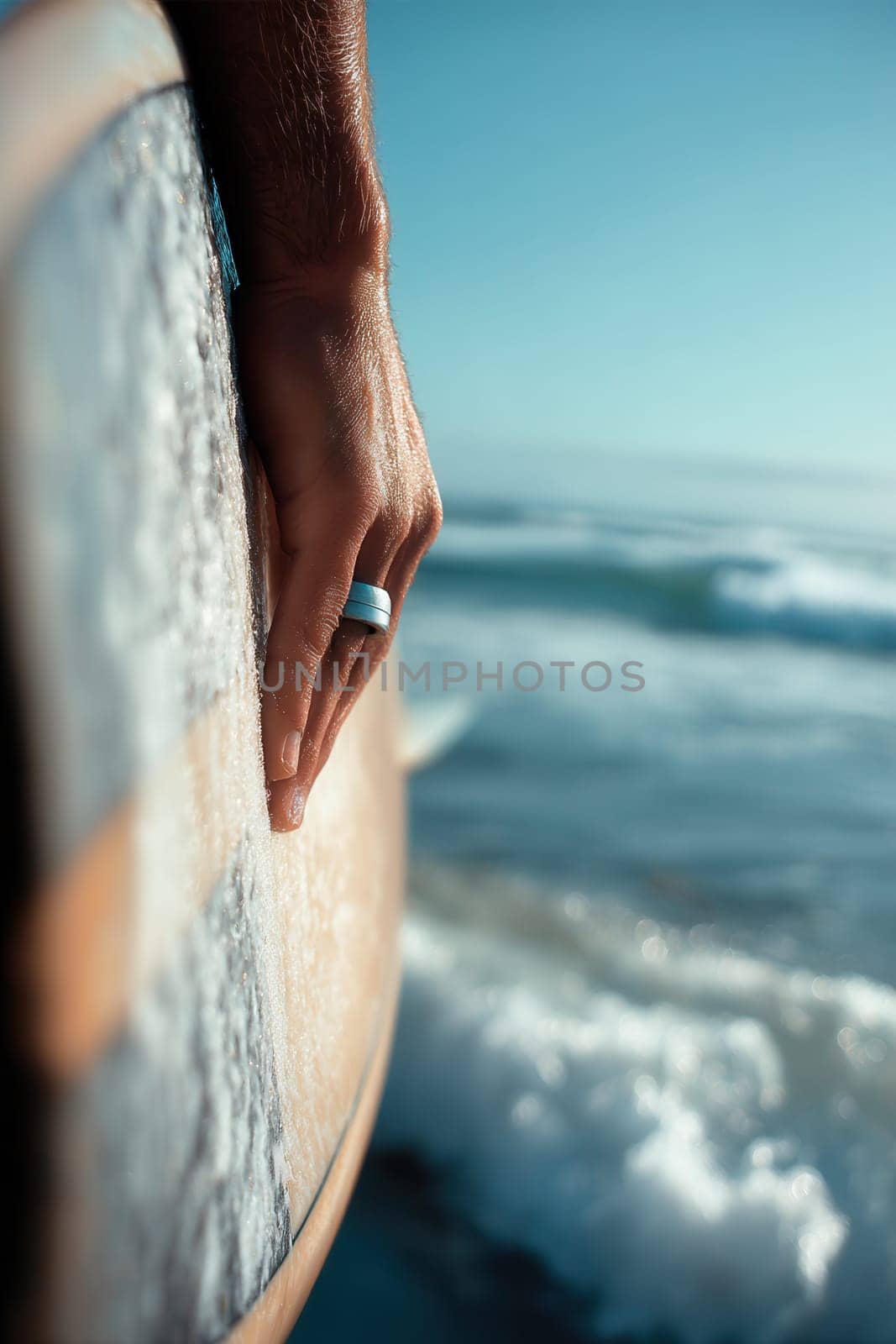 Surfer's hand gently gripping a surfboard above ocean waves, symbolizing freedom and adventure. Perfect visual for wellness campaigns, surfing promotion, beach activities, or travel themes