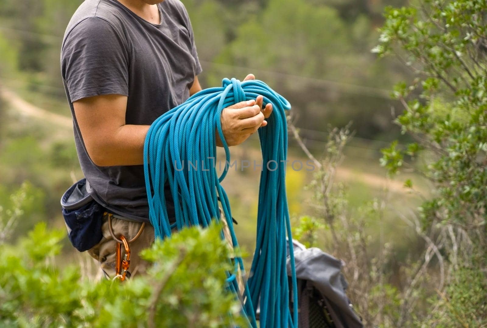 Man with a rope climbing in the mountains. Climbing in the mountains of Spain. Technical mountaineering.