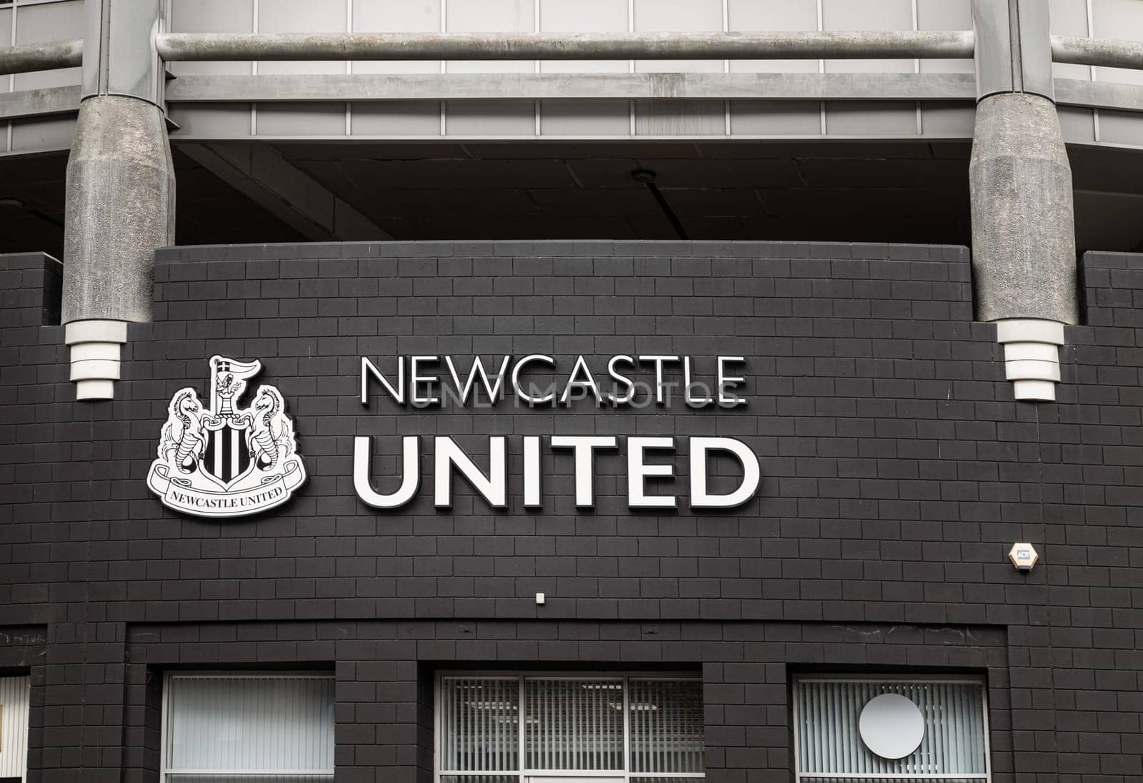 Newcastle, UK - Apr 13, 2025 - View of The Newcastle United FC logo on the exterior of St James' Park stadium is home to stadium of Newcastle United soccer club. use it as your Wallpaper, Poster and Space for text, Selective focus.