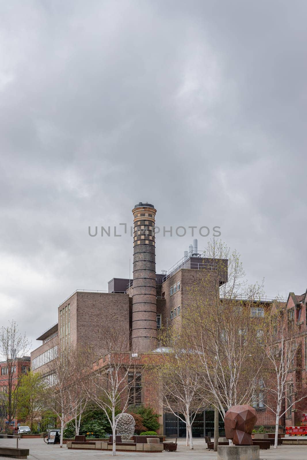 Newcastle, UK - Apr 14, 2025 - Architecture exterior view of The Boiler House and chimney with sky background at Newcastle University. the building housed the Emerson Cavitation Tunnel (propeller testing and hydrodynamics research facility), use it as your Wallpaper, Poster and Space for text, Selective focus.