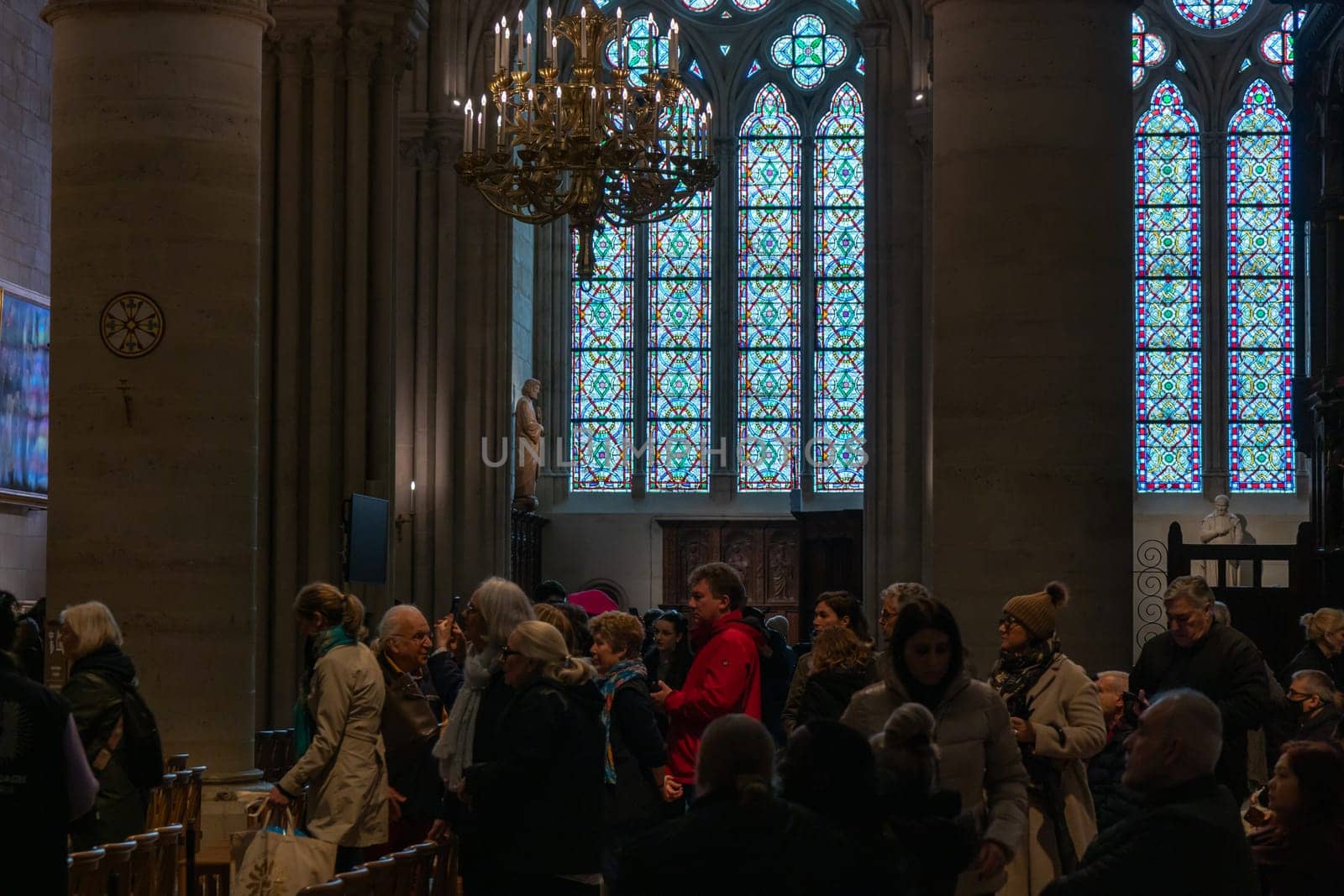 Paris, France - February 22nd 2025 : visitors in The Notre-Dame de Paris, newly re-opened cathedral restored after reconstruction, details of exterior