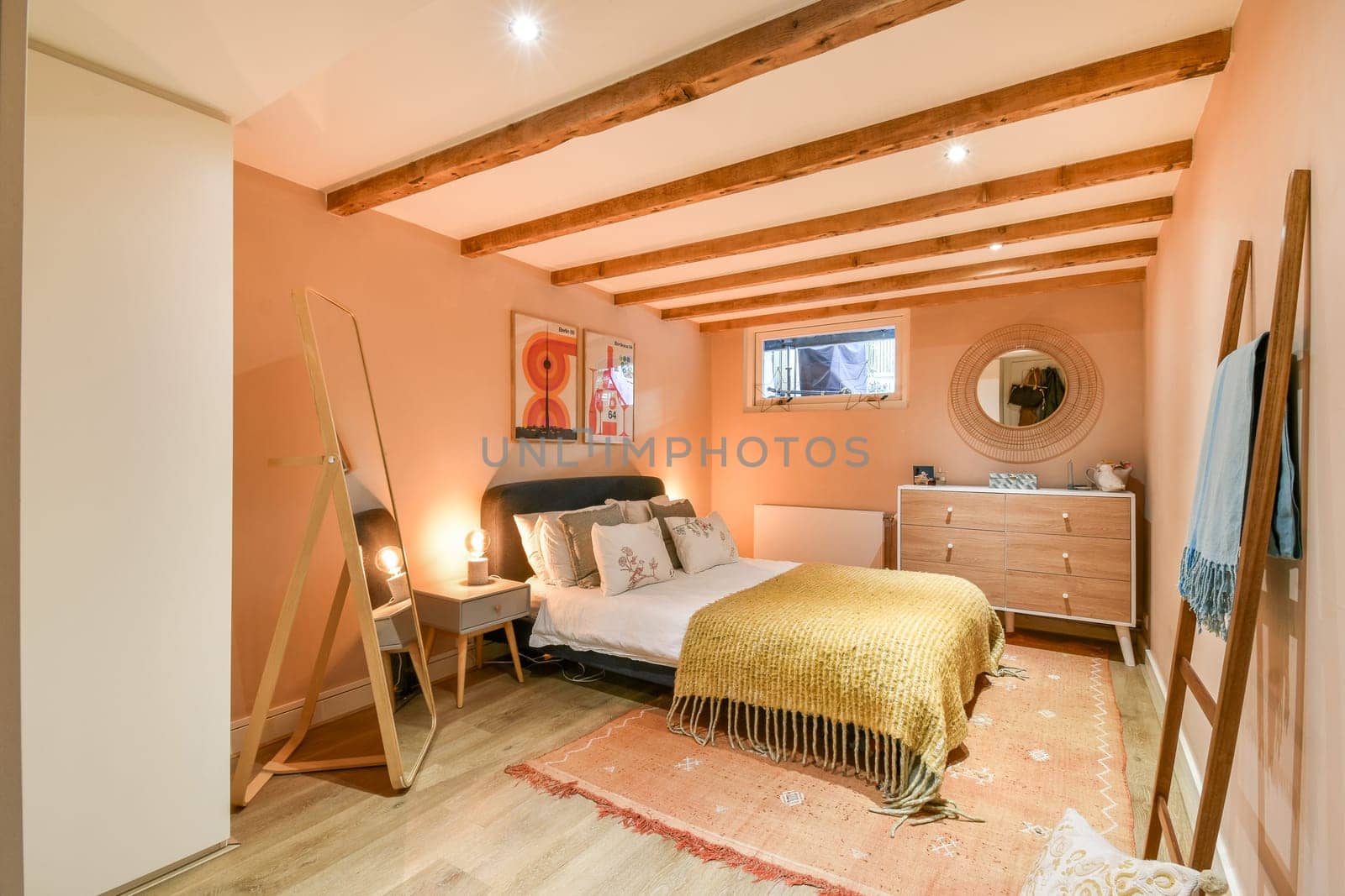 This modern bedroom features warm tones, wooden beams, and stylish decor, creating a cozy and inviting atmosphere for relaxation.
