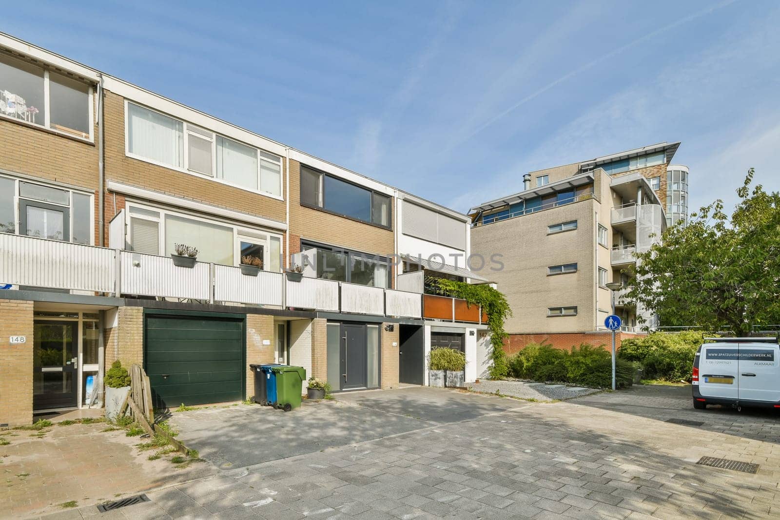Features contemporary buildings and a well-maintained streetscape with greenery, showcasing urban living and architectural design.