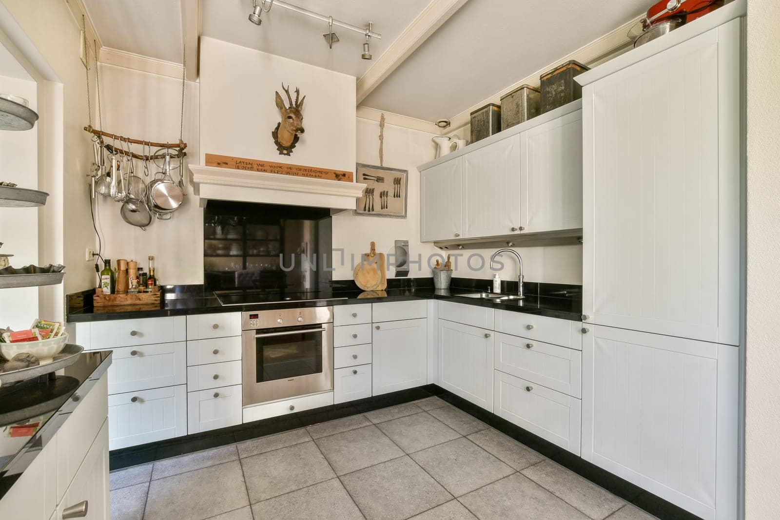 Stylish and contemporary kitchen featuring sleek cabinetry, a central cooking area, and organized storage solutions, ideal for culinary creativity.
