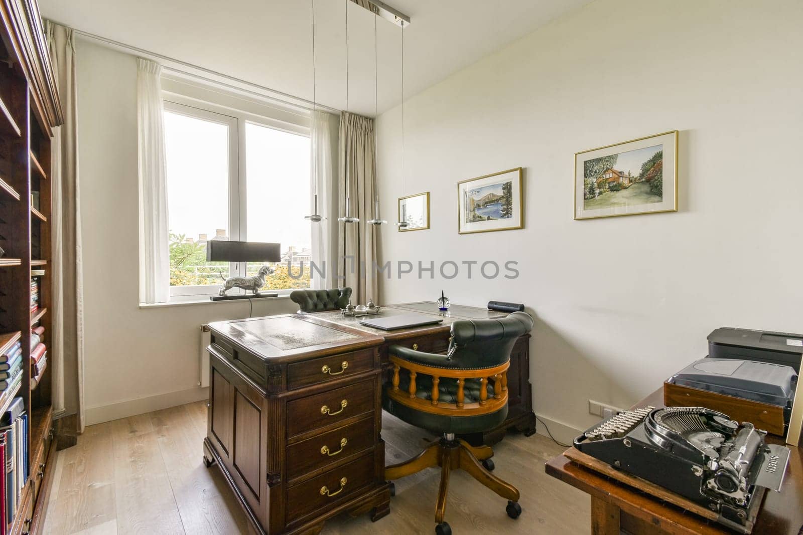 A sophisticated home office featuring vintage furniture, a wooden desk, and ample natural light. Perfect for productivity and creativity.