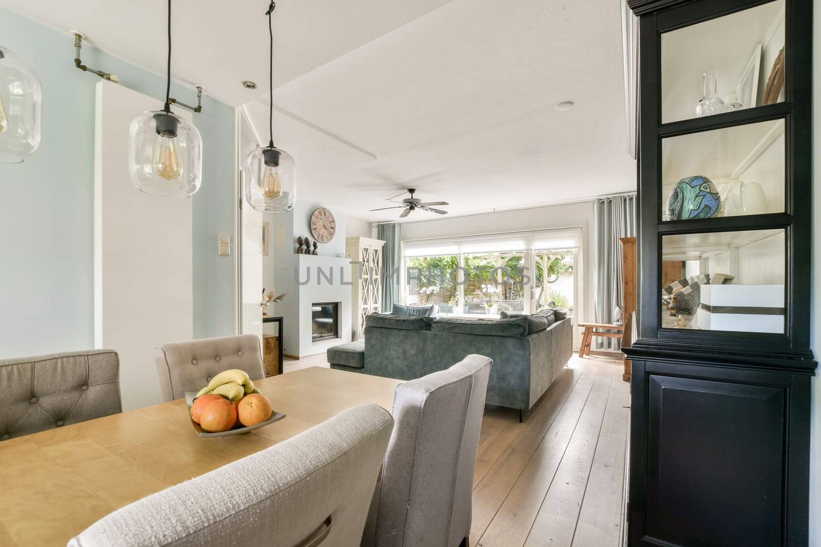 A bright and stylish dining area showcasing a contemporary table set against a backdrop of large windows and an open space.