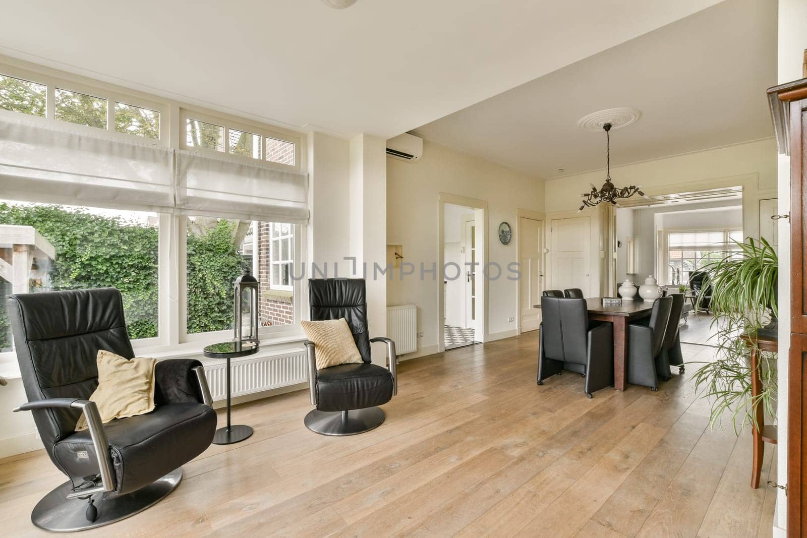 A stylish interior featuring contemporary furniture, large windows, and natural light, creating a warm and inviting atmosphere for relaxation and gatherings.