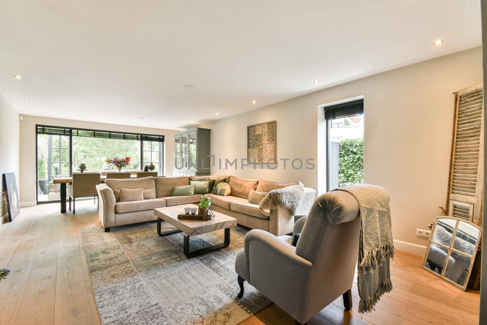A stylish modern living room featuring a cozy seating area, elegant decor, natural light, and a warm ambiance, perfect for relaxation and socializing.