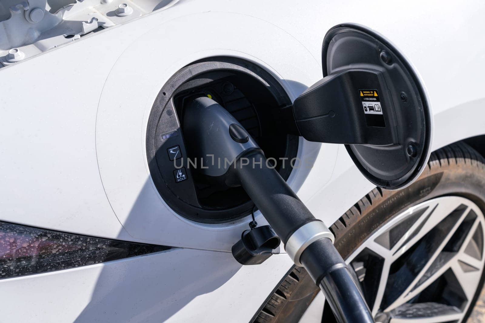 350KW high speed EV charging cable plugged into a white car being charged