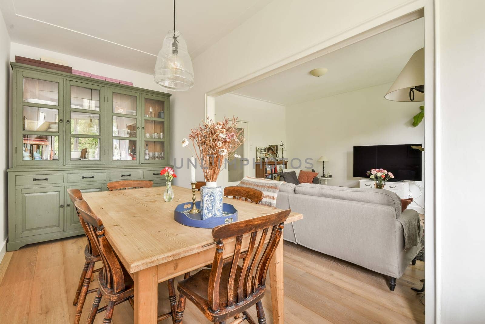 A stylish dining space featuring a wooden table, comfortable chairs, and a contemporary decor that creates a warm and inviting atmosphere.