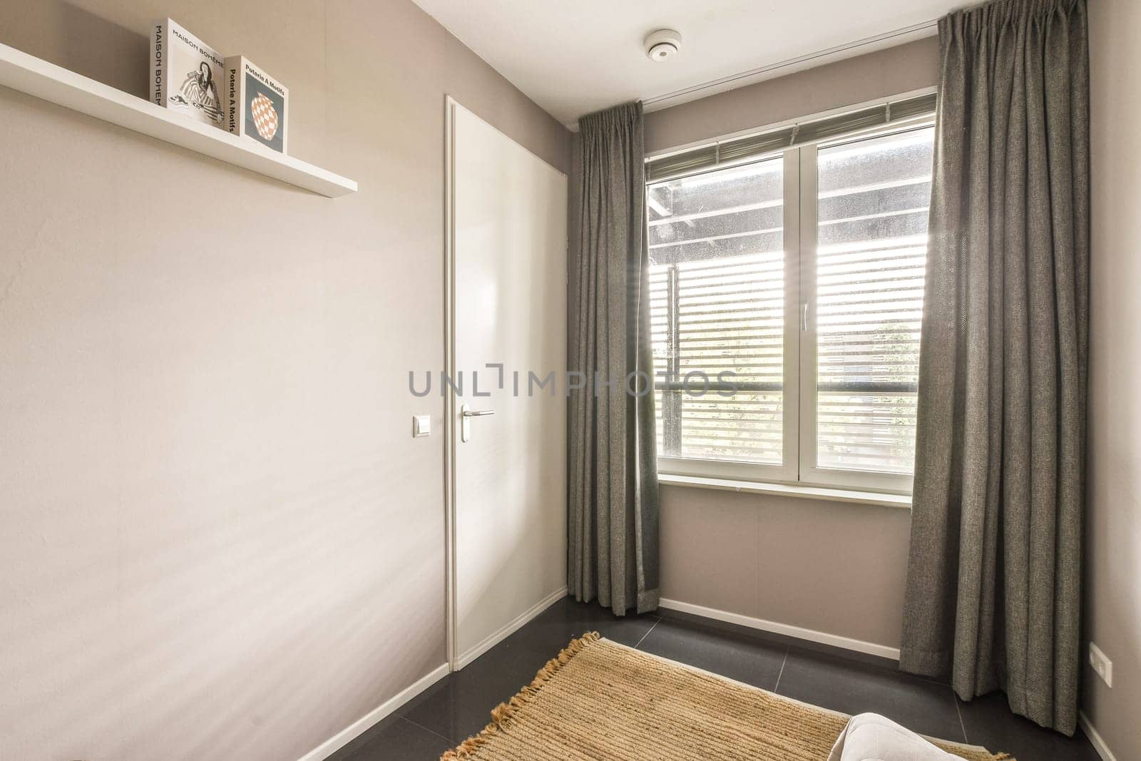 A minimalist bedroom featuring soft tones, natural lighting, and simple decor emphasizes tranquility and simplicity in design aesthetics.