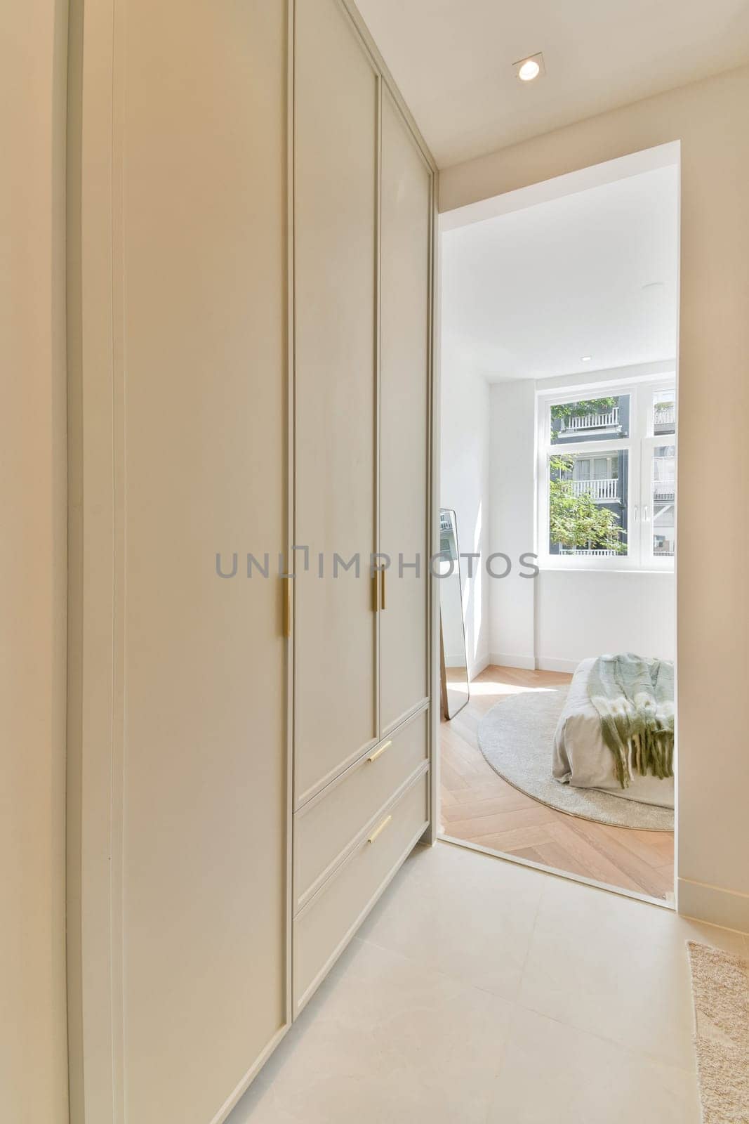 A sleek and modern interior design showcases a minimalist room featuring light colors, a spacious layout, and contemporary furniture for a calming atmosphere.