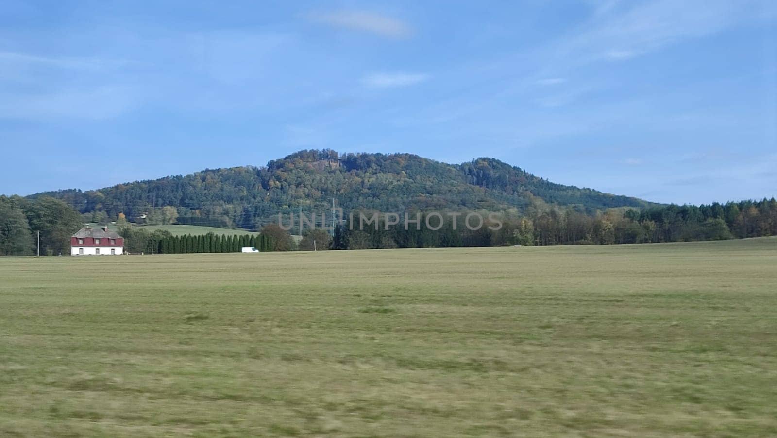 Open grassy landscape evening travel landscape nature background green grass blue sky opendoor street . High quality photo mounted shotlisttravel
