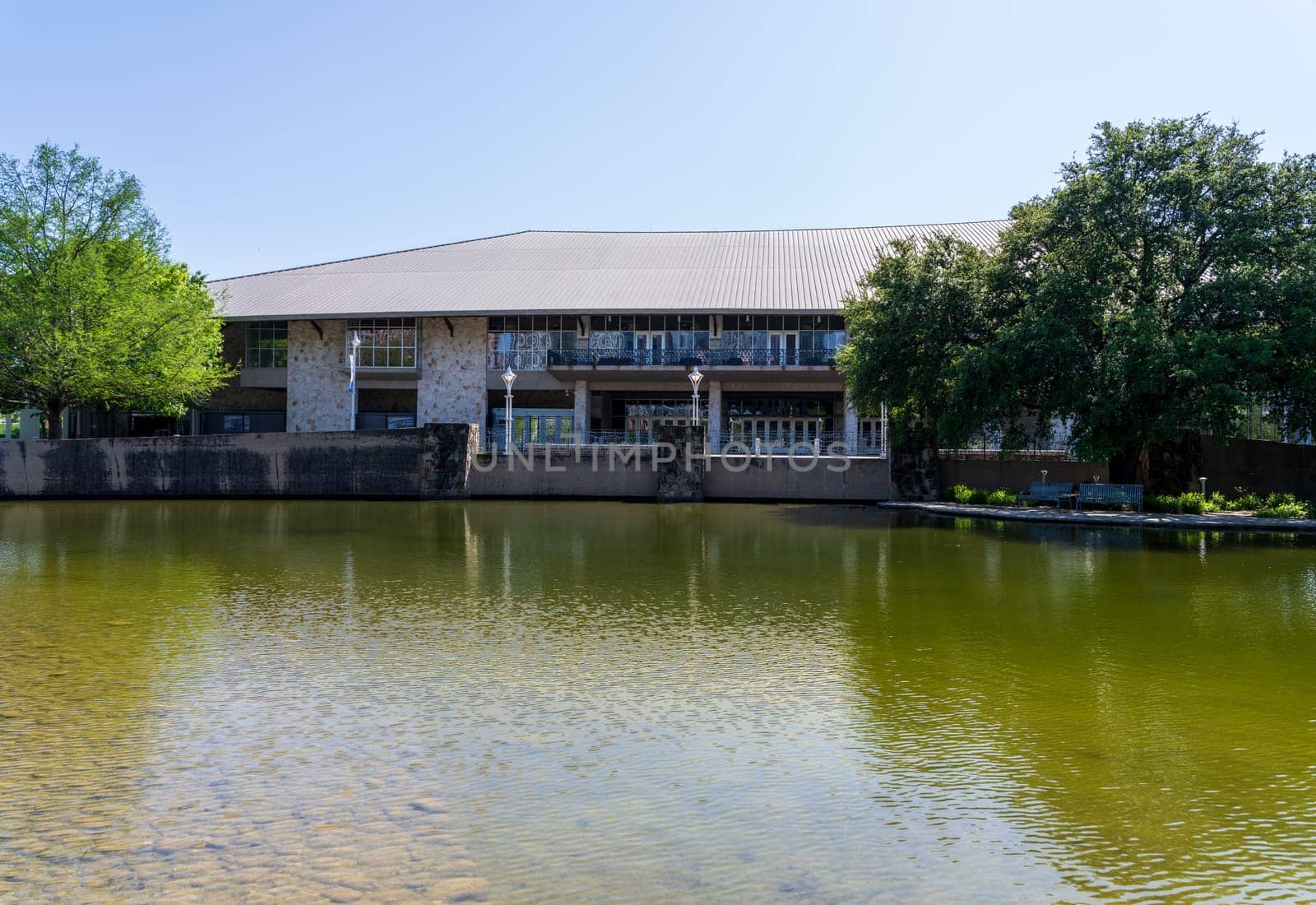 Austin, TX - 10 April 2025: Facade of Palmer Center in Town Park seen across the Palmer lake in Austin Texas