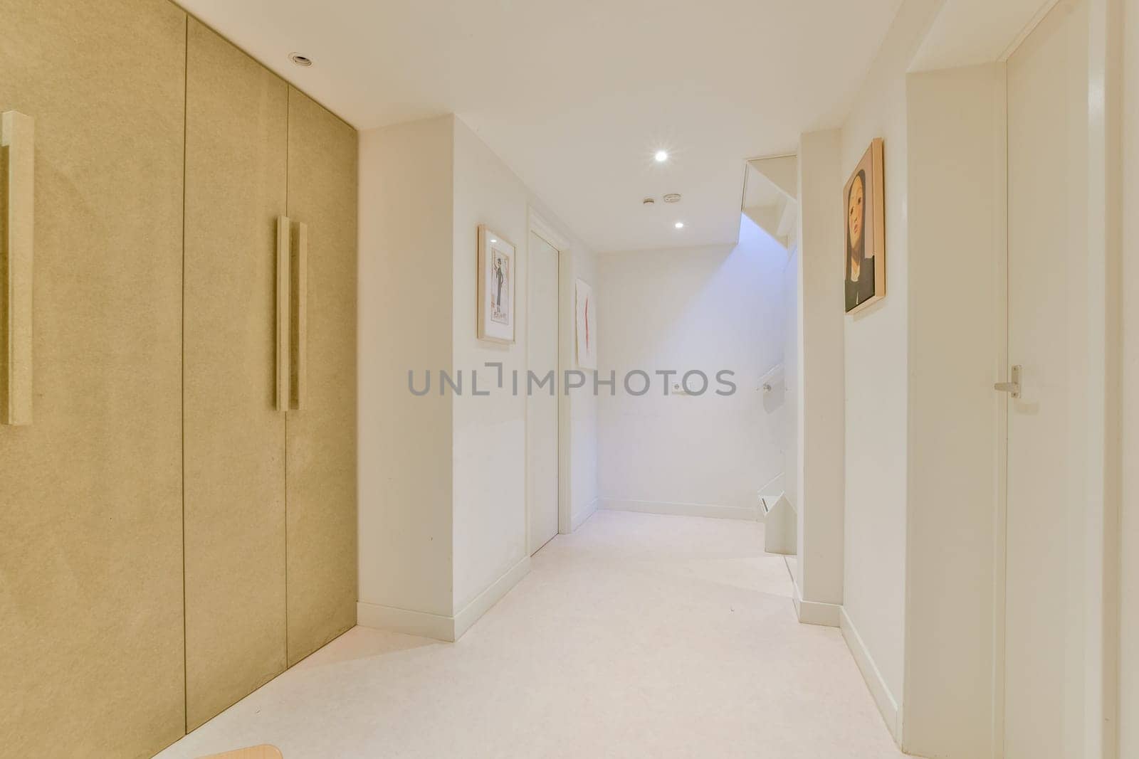 A contemporary interior hallway featuring clean lines, minimalist decor, and subtle lighting. The space creates a serene atmosphere with soft tones.