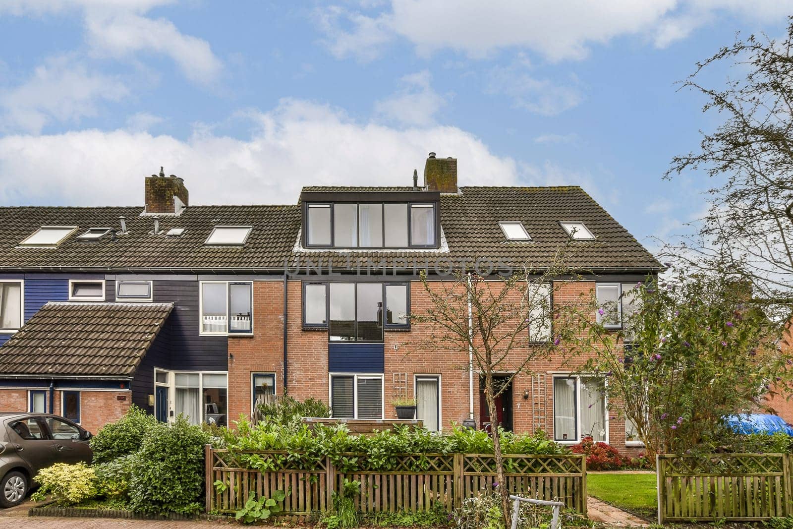 A picturesque view of townhouses showcasing a mix of brick and modern design accompanied by lush greenery and a welcoming atmosphere.