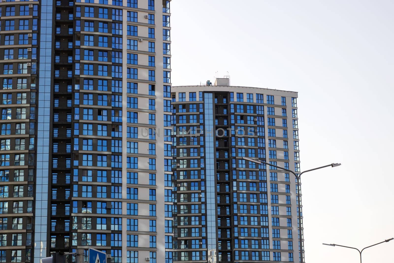A very tall building prominently features a large sign that clearly displays the letter A on its facade, making it easily noticeable