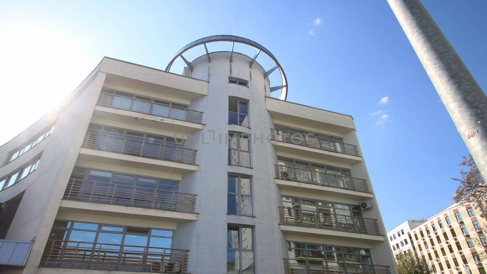 A large and impressive white building standing tall against a serene blue sky in the background, showcasing its architectural beauty and design elements