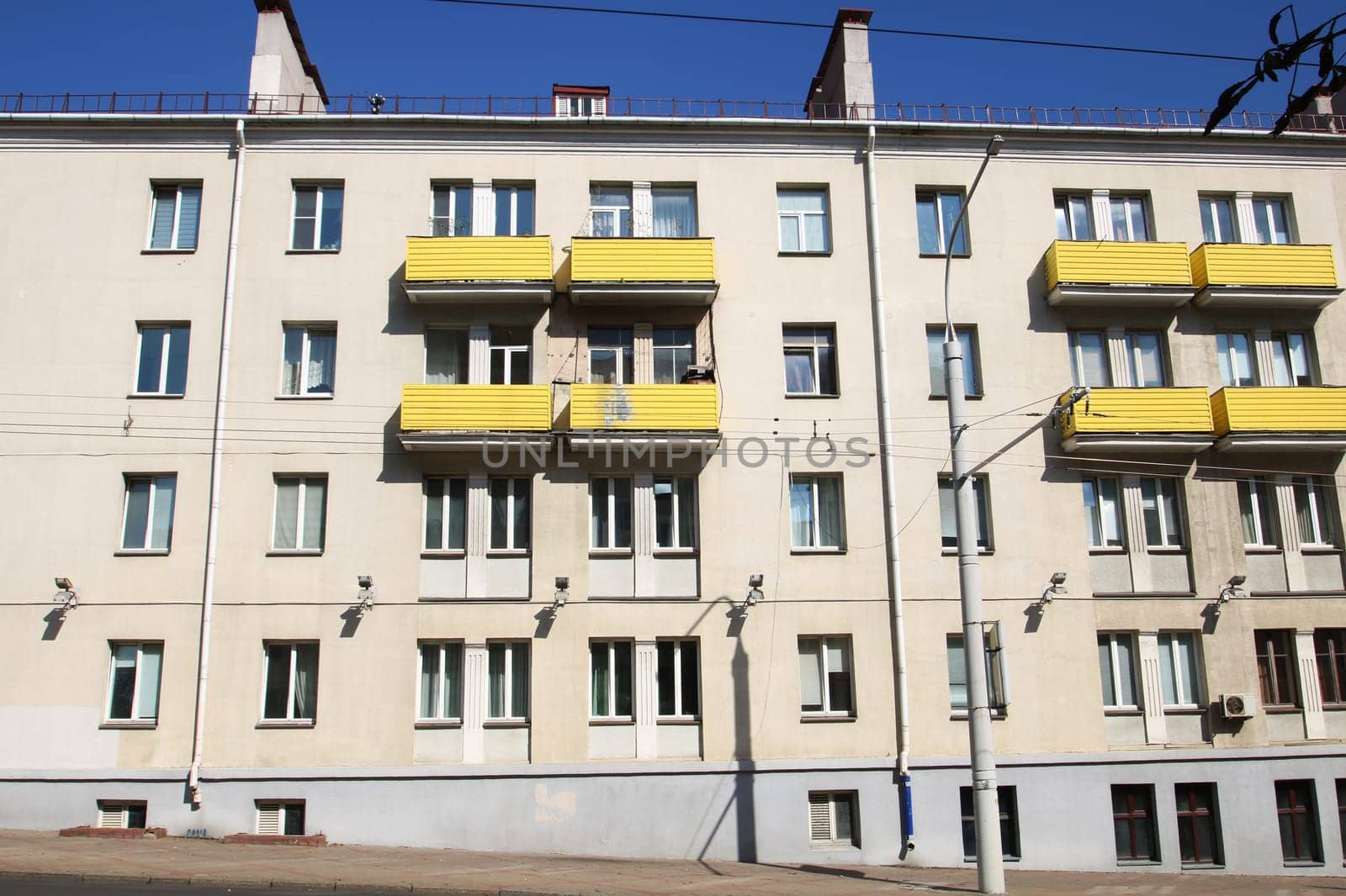 This is a description of a unique building featuring striking yellow balconies adorning its side and contributing to the urban landscape