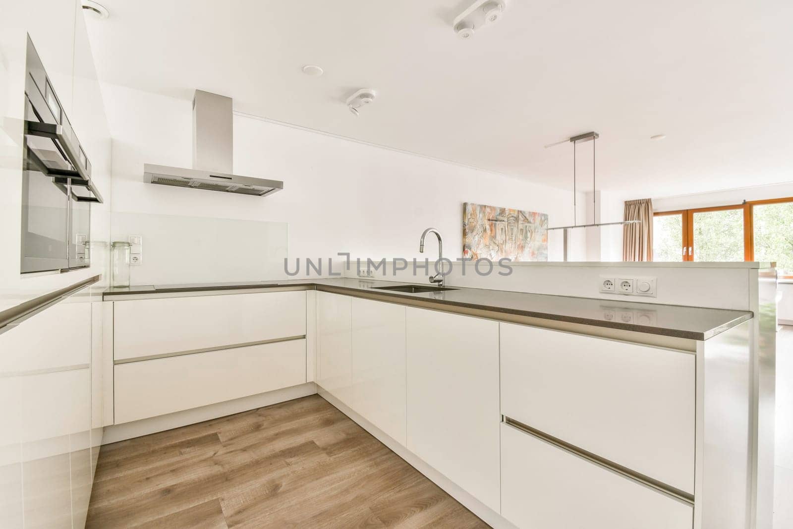 A sleek and modern kitchen featuring minimalist design elements and a clean aesthetic, with ample natural light and contemporary finishes.