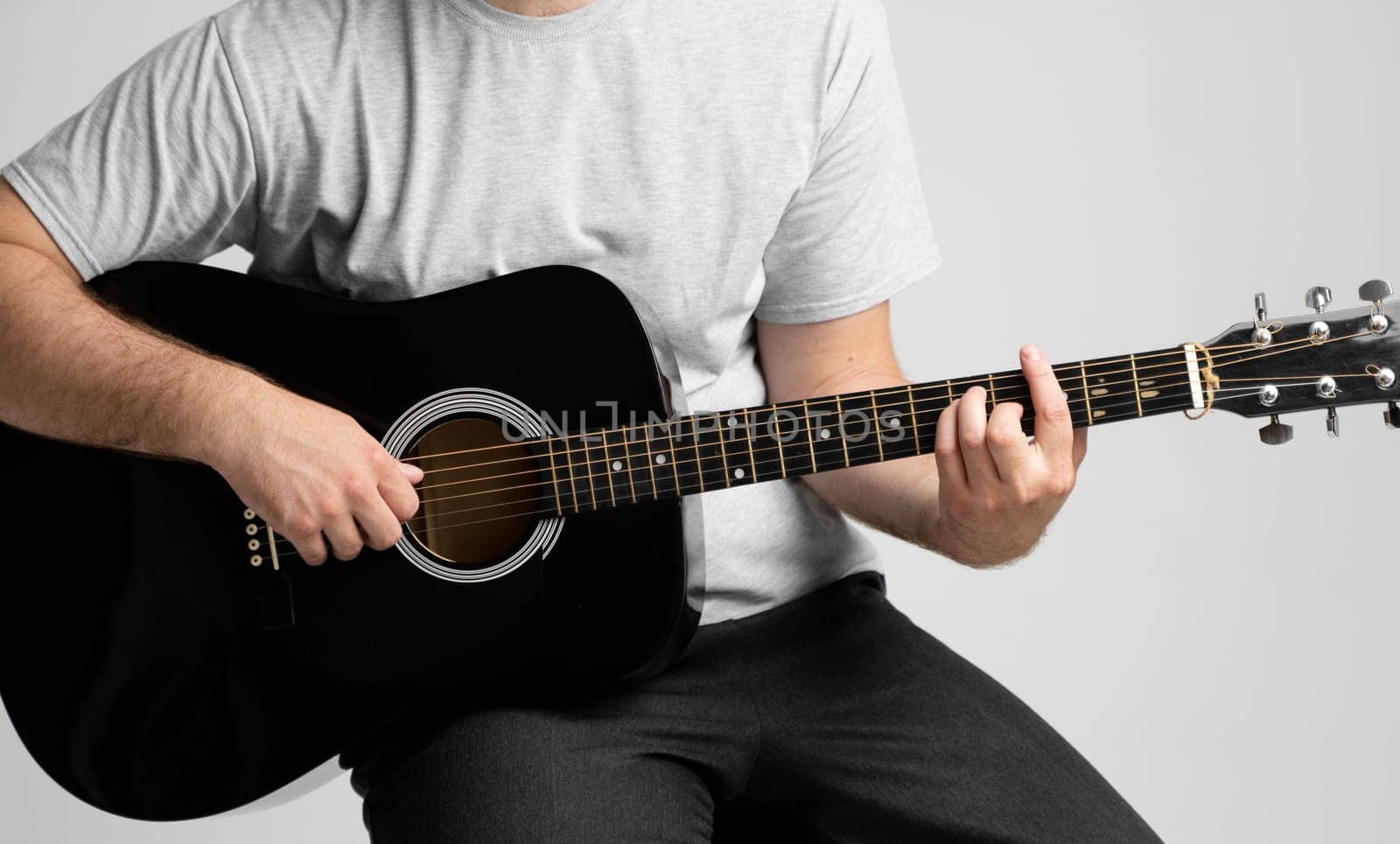 Man with a guitar in hands playing a song