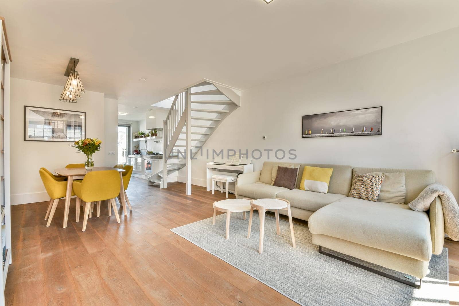 A stylish modern interior featuring a cozy living room with a comfortable sofa, a dining area, and elegant decor. Bright, spacious design enhances the ambiance.