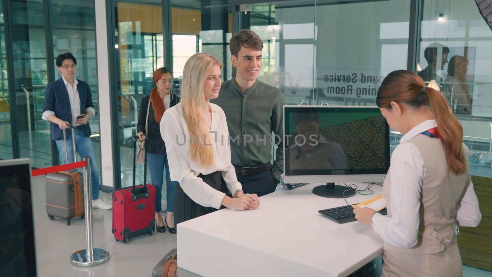 Male tourist in international airport at check-in counter checking staff giving passport and boarding pass from the attendant for he flight, travel and holiday season trip concept