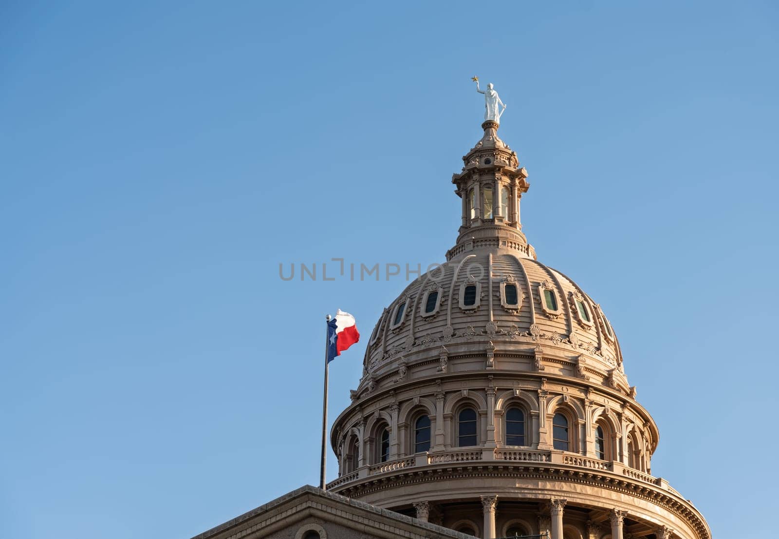 Detail of the dome of the Texas State Capitol building in Austin with sun low in the sky before sunset