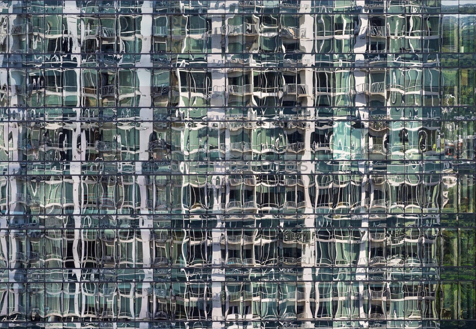 Complex abstract reflections of apartment tower in the windows of a condo tower in downtown Austin Texas