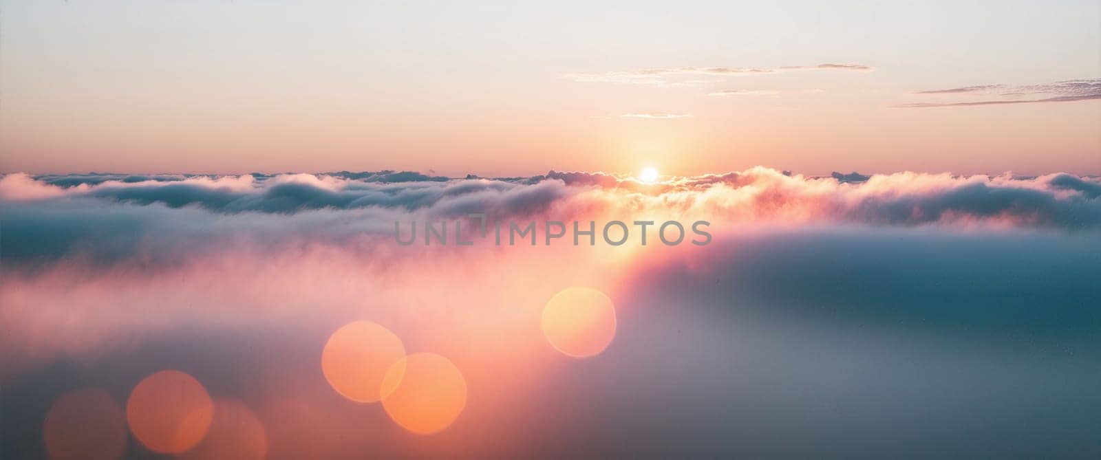 The breathtaking sight features delicate wispy cirrus clouds gracefully floating in a vibrant blue sky. A radiant half moon adds a celestial touch to the stunning sunset colors of orange and yellow.