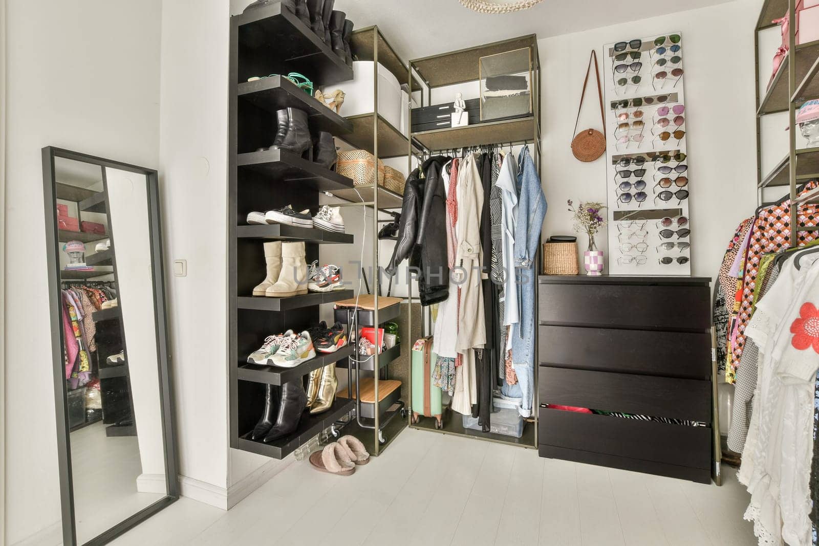 A sleek modern wardrobe showcasing organized clothing and accessories, featuring a mirror and well-arranged shelves for optimal space utilization.