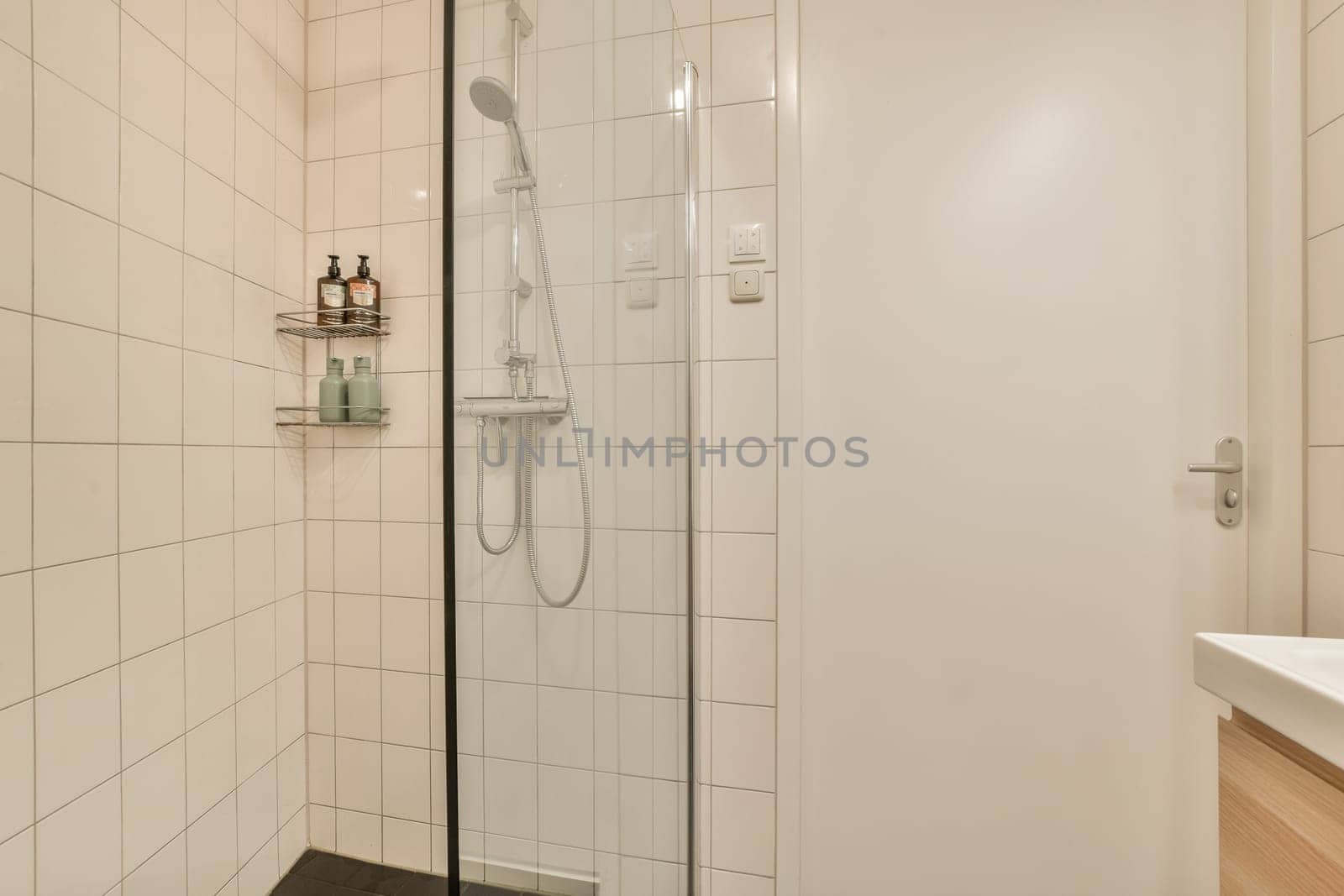 A sleek and contemporary shower room featuring a glass enclosure, minimalist design, and light-colored tiles for a clean, spacious feel.