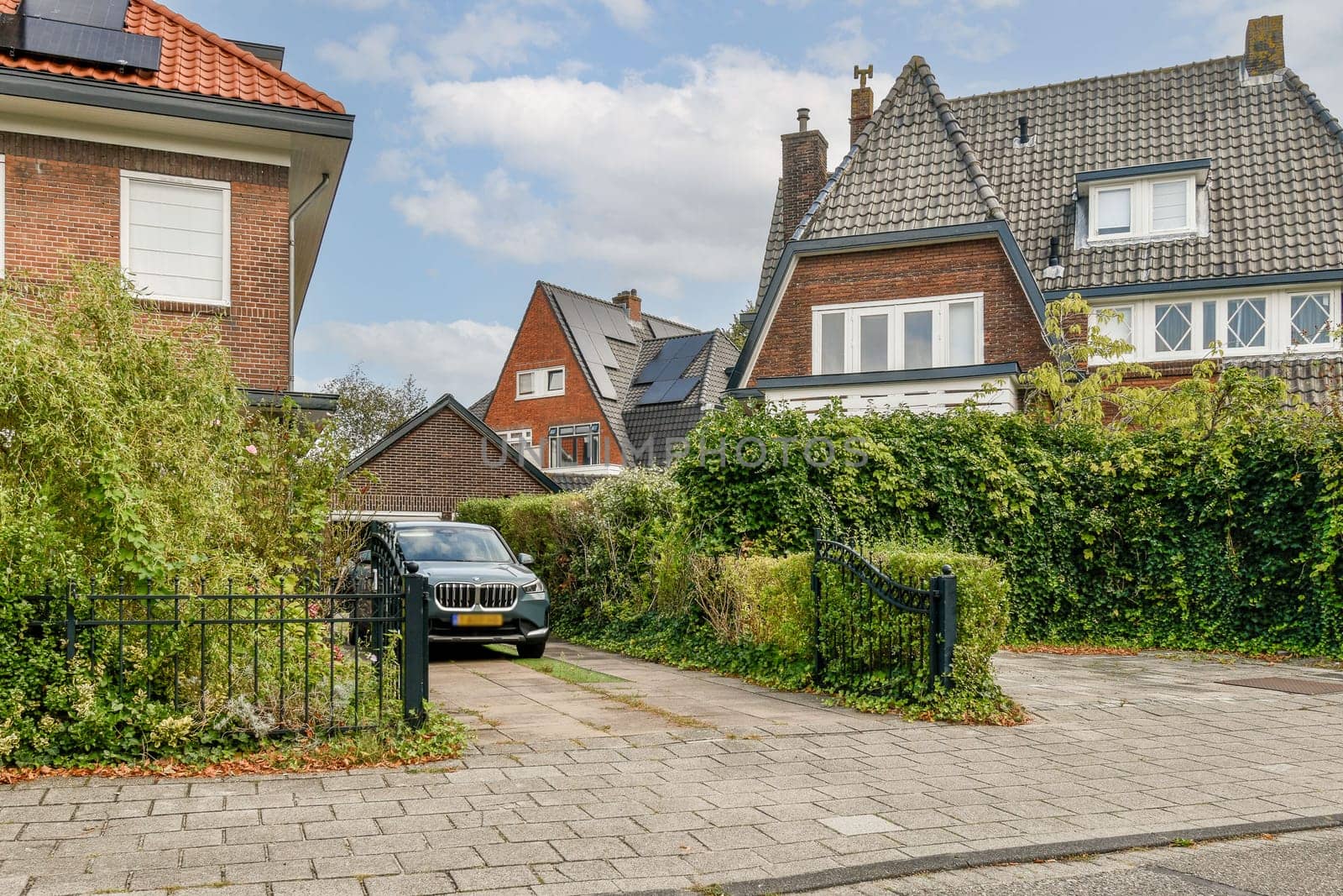 A picturesque view of a residential neighborhood featuring attractive houses, lush greenery, and well-maintained walkways enhancing the suburban charm.