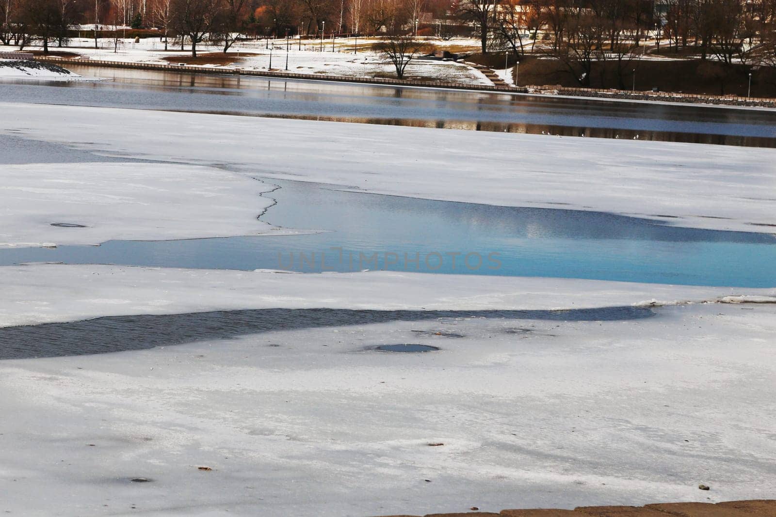 Small frozen river landscape in spring time before icedrift.