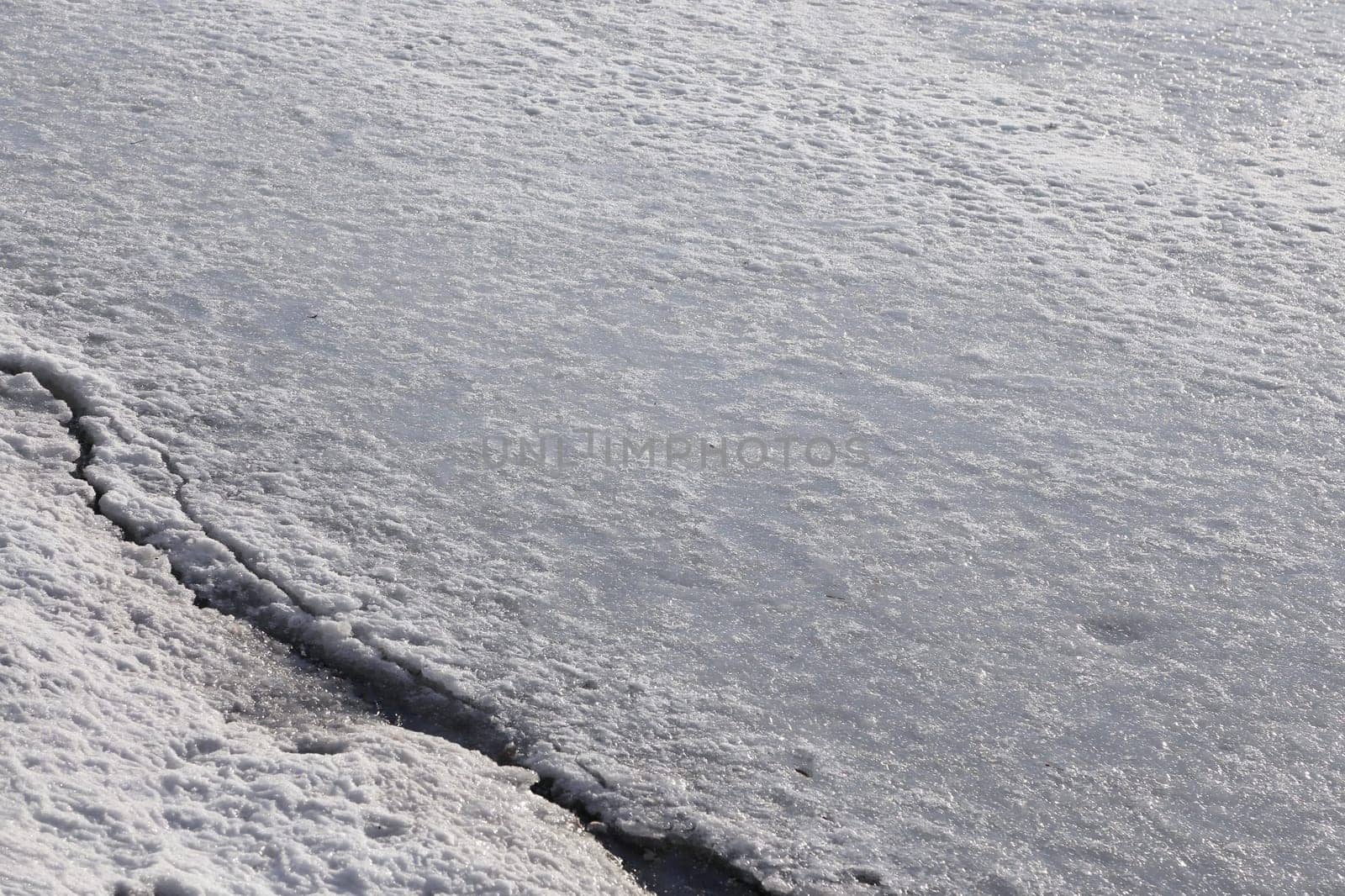 The surface of the river is covered with ice and snow.