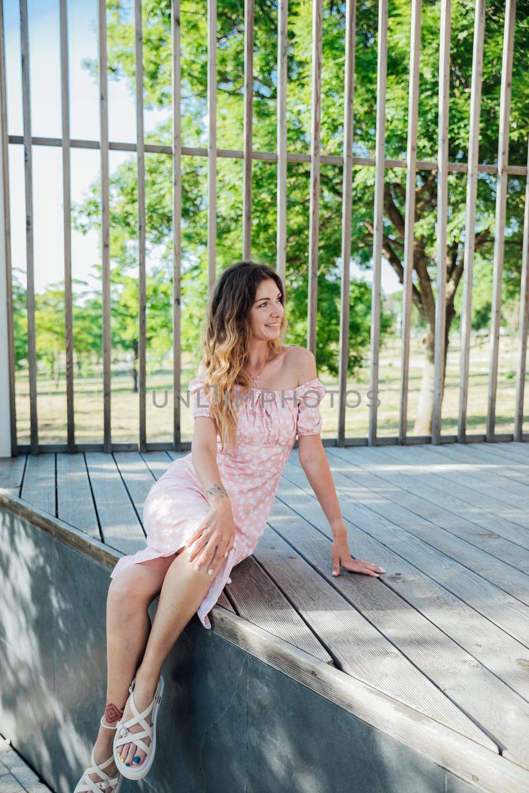 Woman in summer light dress in park on walk