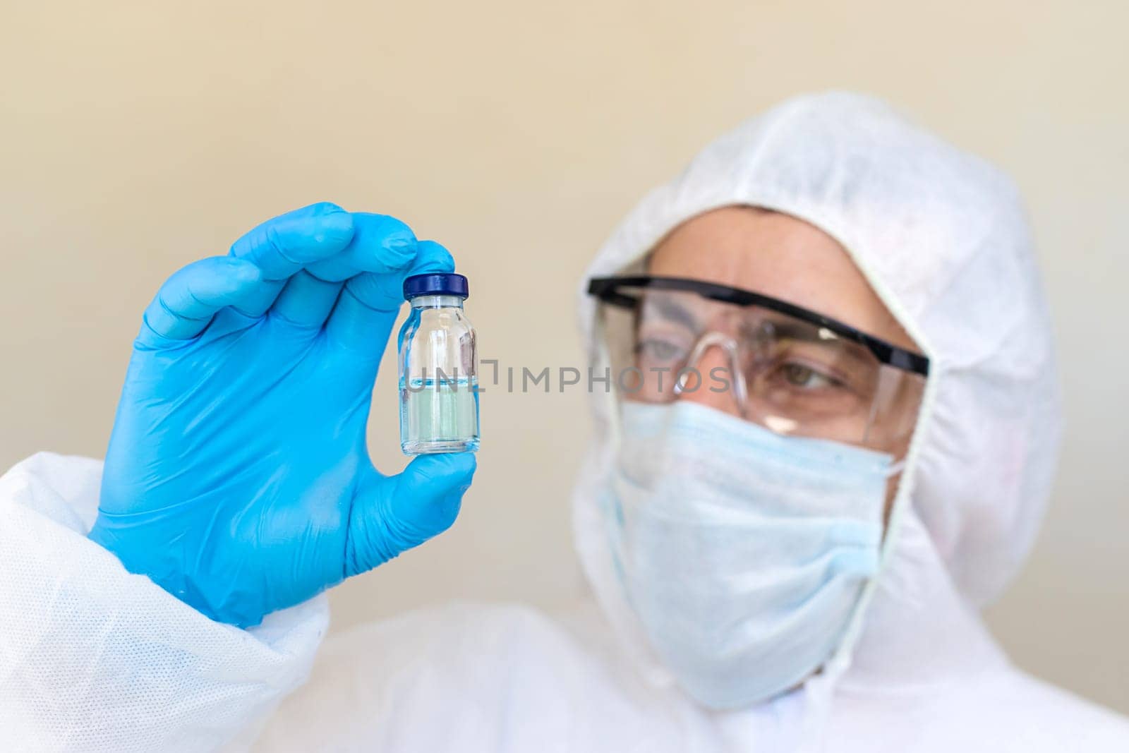 Medicine in a bottle in the hands of a doctor. Selective focus. vaccine
