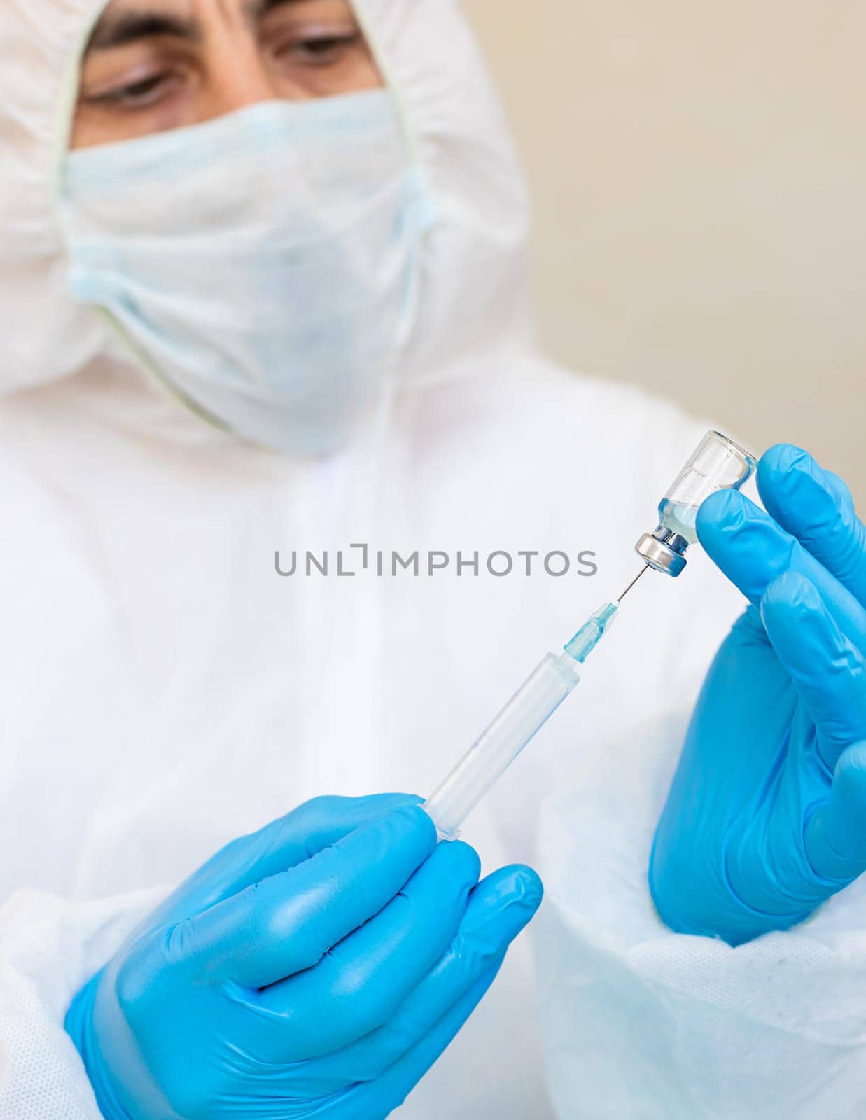 Medicine in a bottle in the hands of a doctor. Selective focus. vaccine