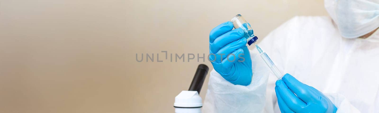Medicine in a bottle in the hands of a doctor. Selective focus. vaccine