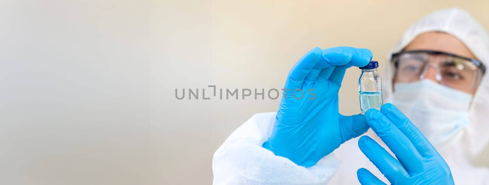 Medicine in a bottle in the hands of a doctor. Selective focus. vaccine
