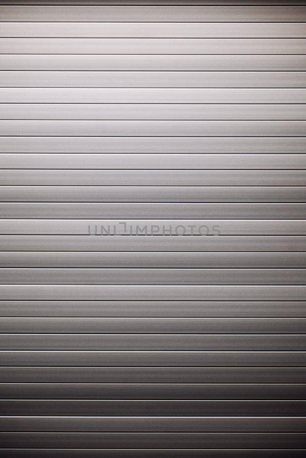 Metallic background formed by a corrugated iron sheet with horizontal stripes and a gradient from light gray to dark gray
