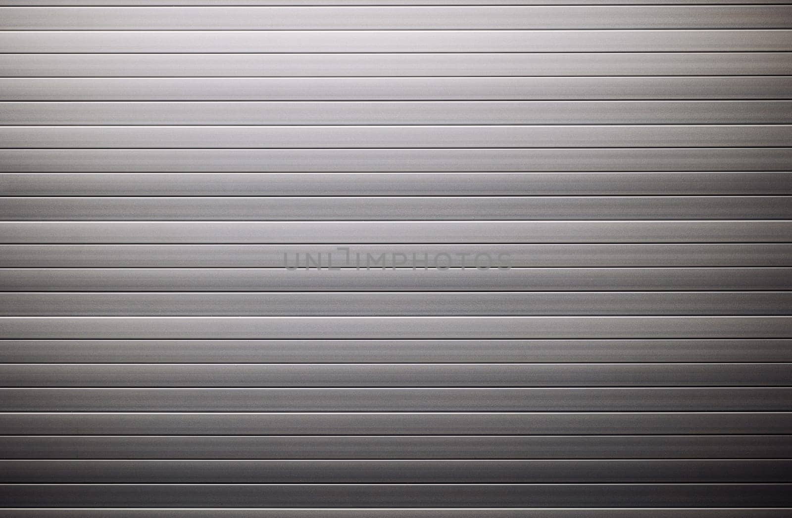 Metallic background with horizontal lines creating a corrugated effect, ideal for industrial and abstract designs