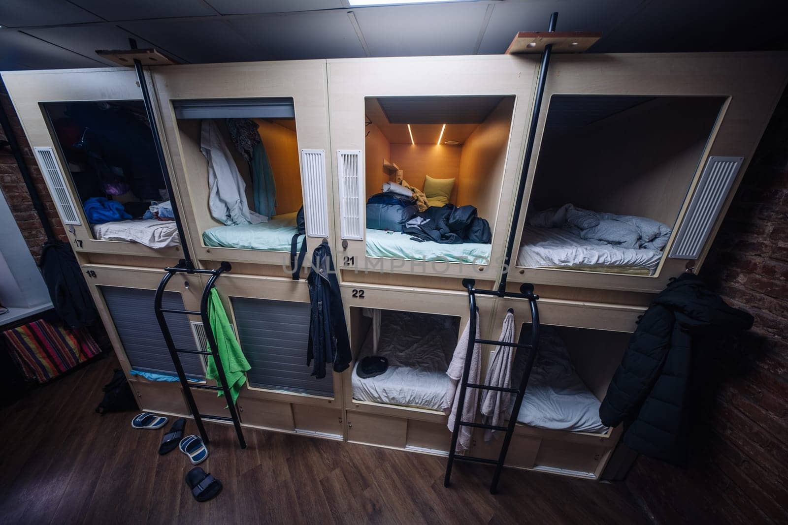 Cozy capsule hotel room providing compact and private sleeping spaces for travelers