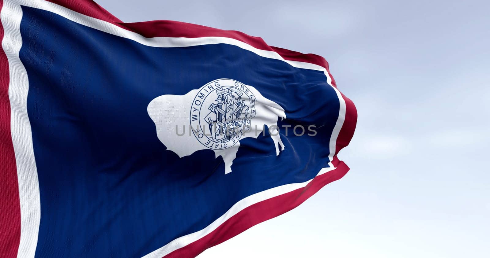 3D render of the Wyoming state flag featuring the bison and state seal, fluttering in the wind and symbolizing pride, identity, and freedom in the United States.